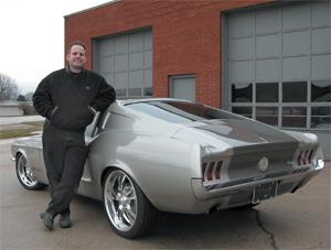 Troy Trepanier stands next to the FastForward Fastback 1967 Mustang